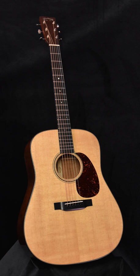 Martin dreadnought acoustic guitar with light top, dark rosette, and pearl logo on headstock