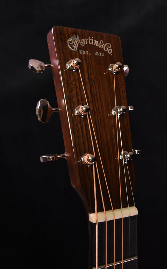 Martin guitar headstock with gold tuning machines and Martin logo