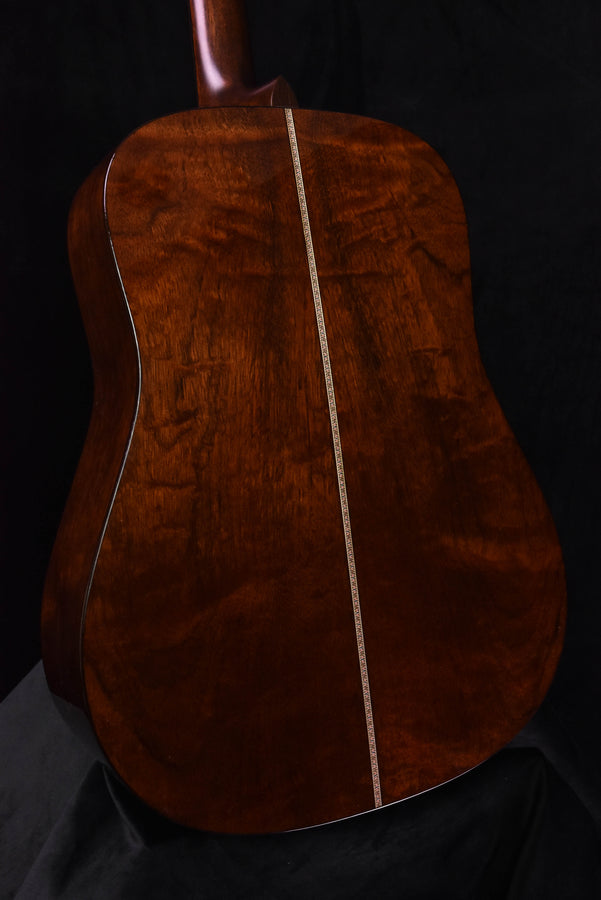 Close view of quilt mahogany back with dark center strip and rich wood grain