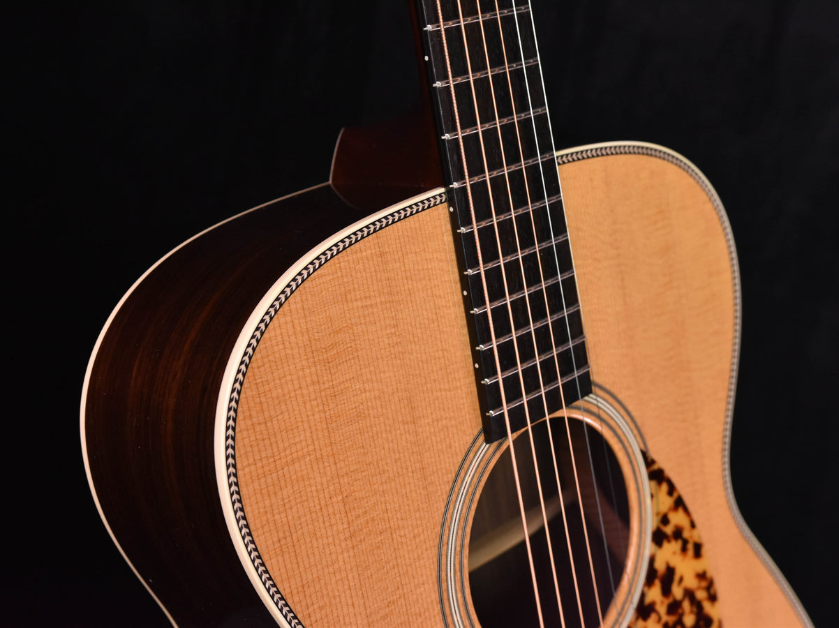 Acoustic guitar neck and upper bout with binding trim and curved body edge