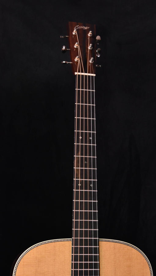 Acoustic guitar with dark fretboard and headstock above the light wood body top