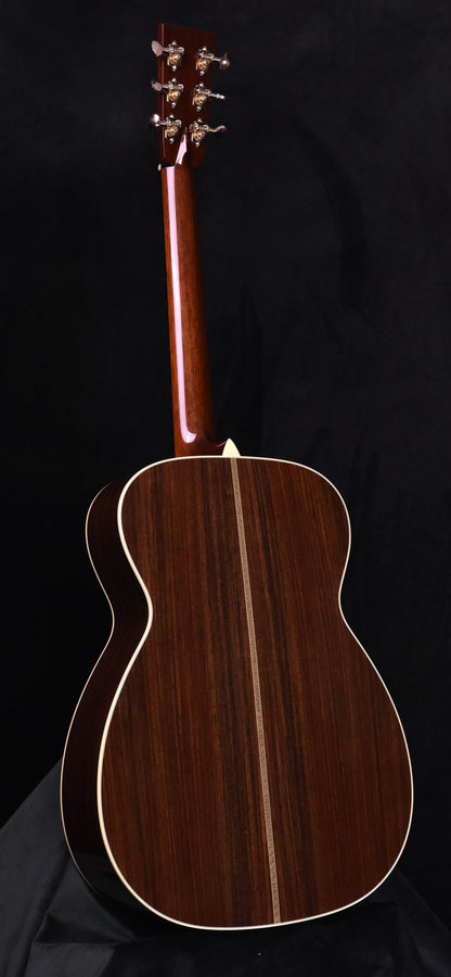 Acoustic guitar back view with dark wood finish and cream binding outline