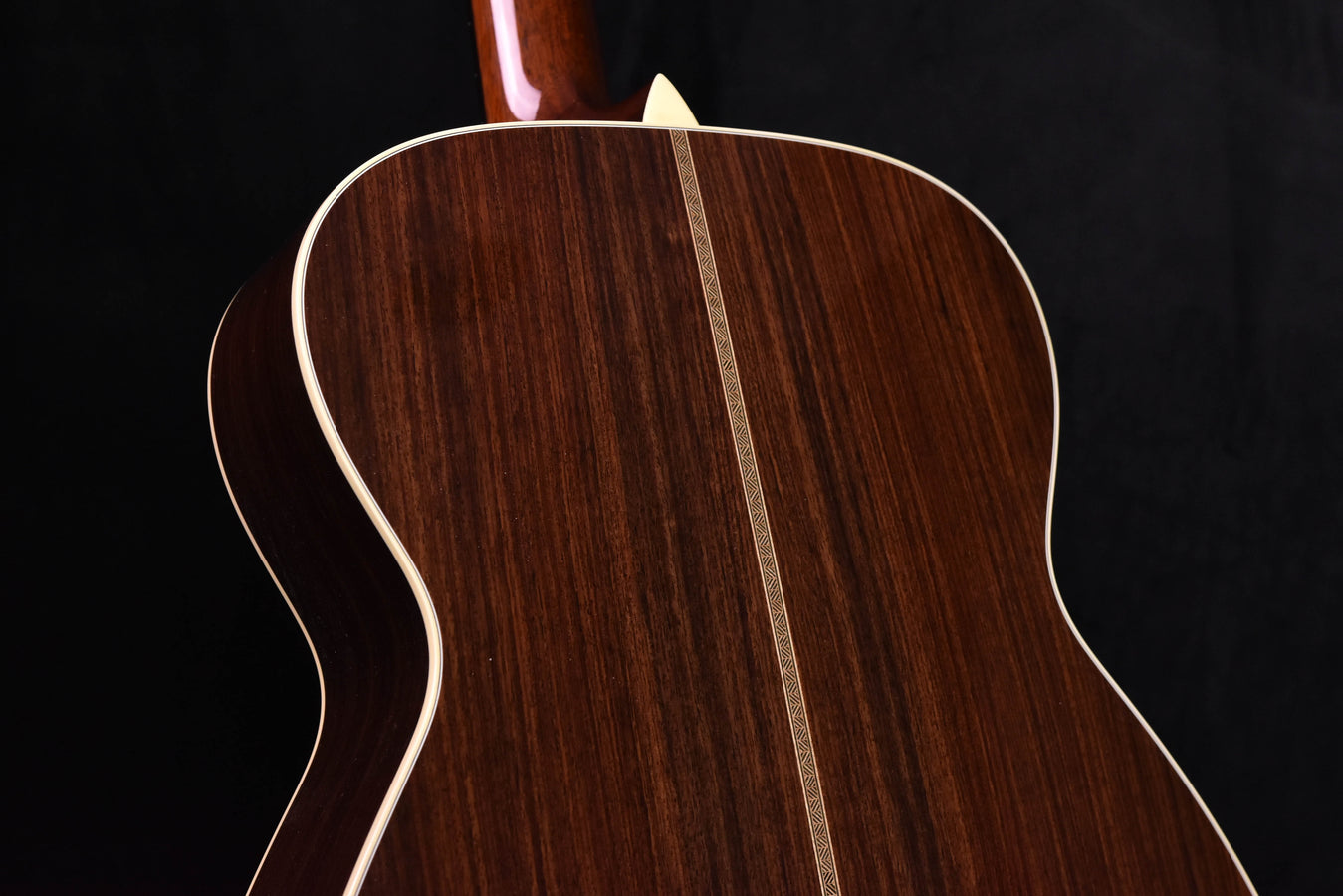 Used acoustic guitar body top with center seam and dark wood grain, side view