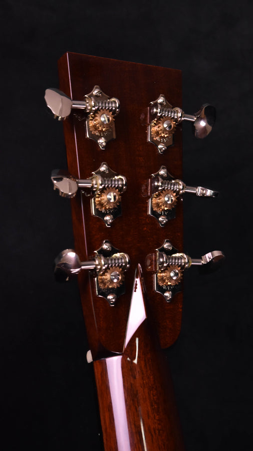 Used acoustic guitar headstock close-up showing tuning machines and mounting plates