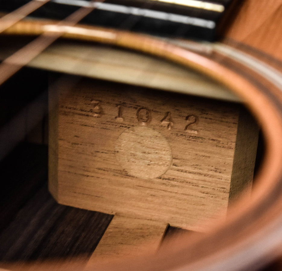 Used acoustic guitar interior wood stamp with faint numbers, close-up detail