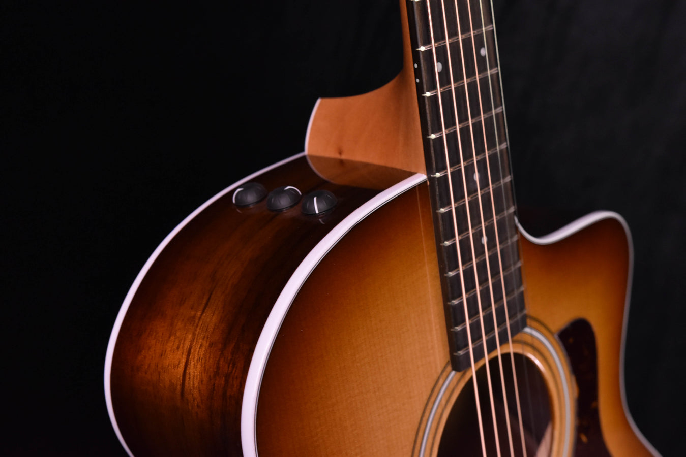 214 CE-K SB acoustic guitar, glossy upper bout curve with strings and bridge visible