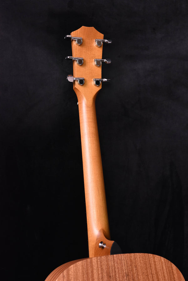 Acoustic guitar headstock with four tuning pegs and natural wood finish
