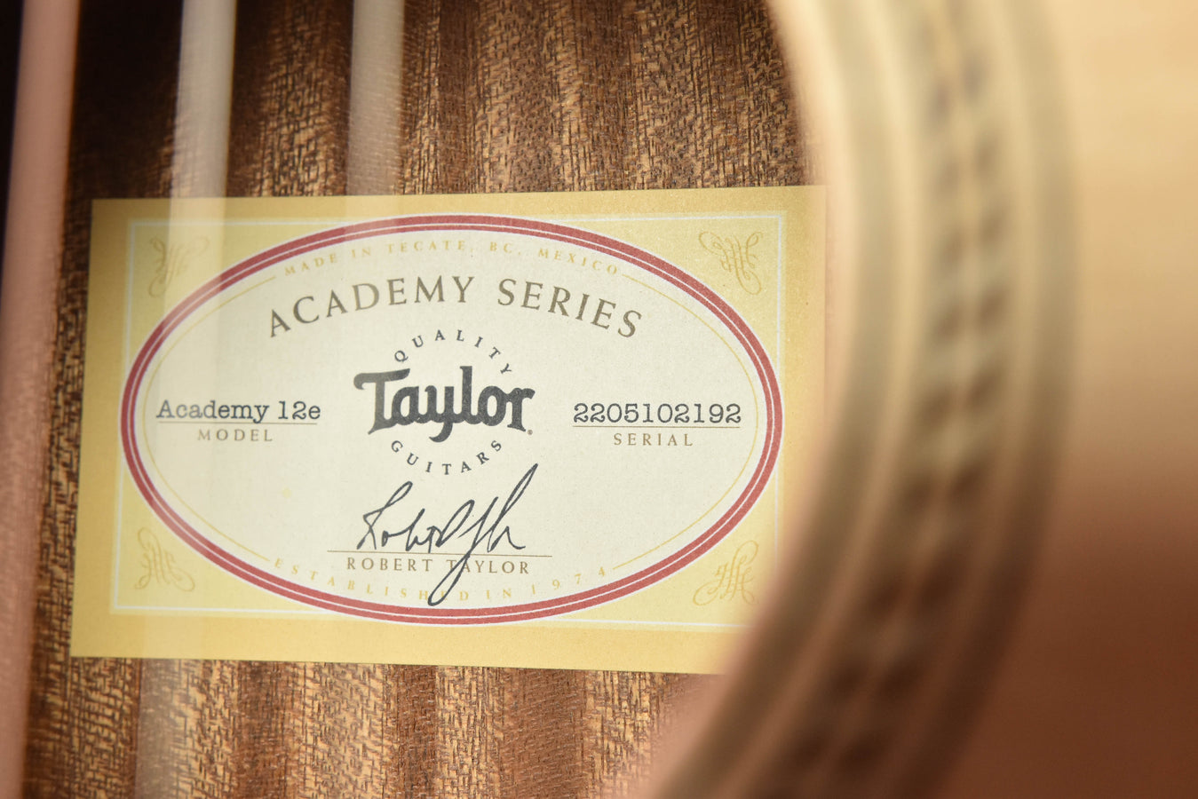 Academy Series guitar label with Taylor logo and 12E model text