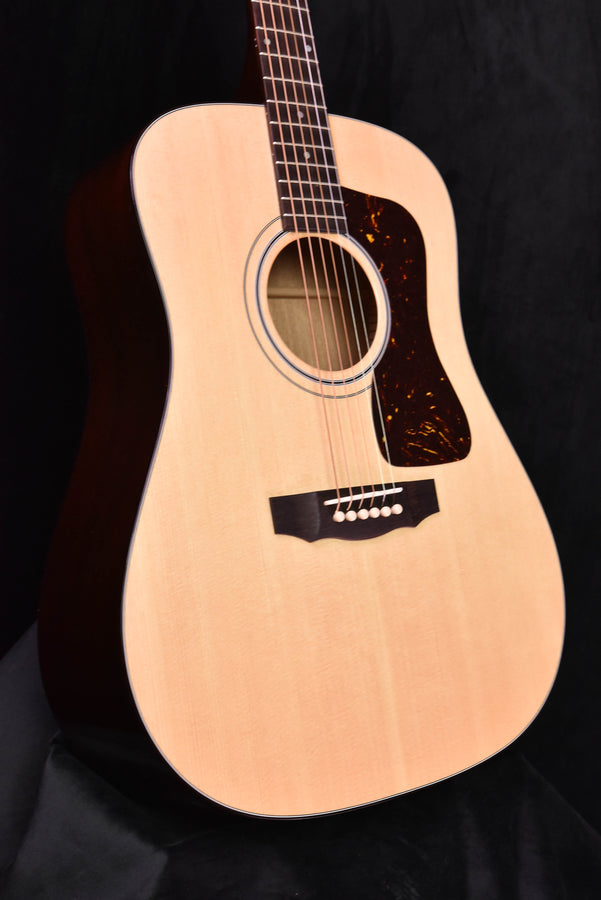 Natural-finish Guild D-40 acoustic guitar with soundhole and pickguard visible