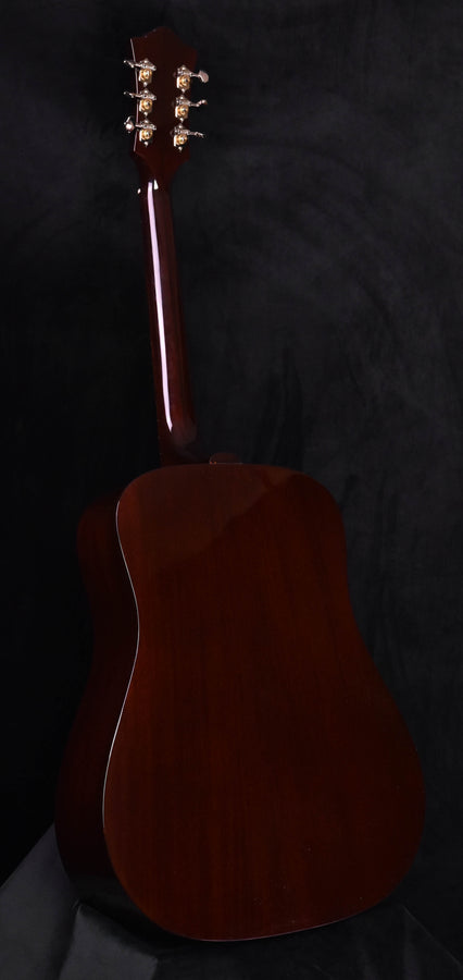Natural-finish acoustic guitar body from backside angle
