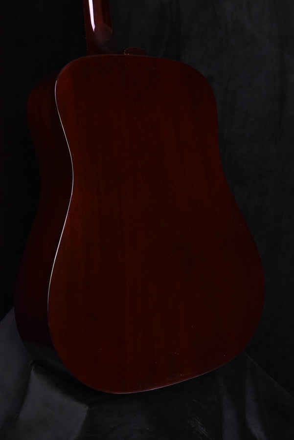Back view of natural-finish acoustic guitar body with dark wood finish