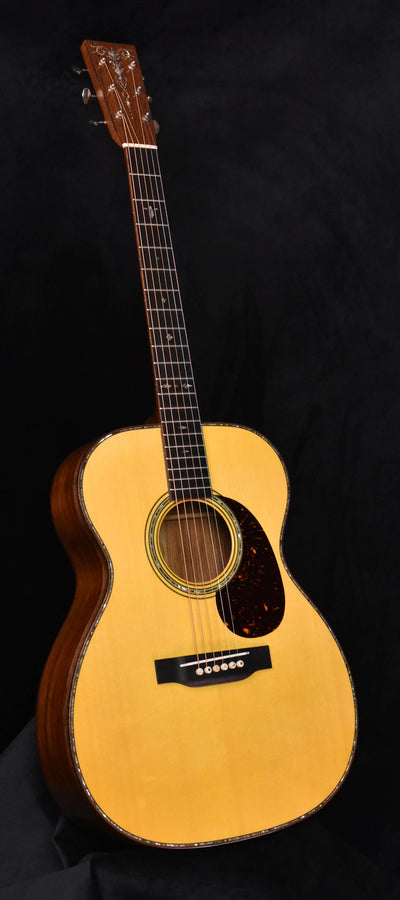 Used acoustic guitar with light top, dark tortoise-style pickguard, and rosewood-toned neck