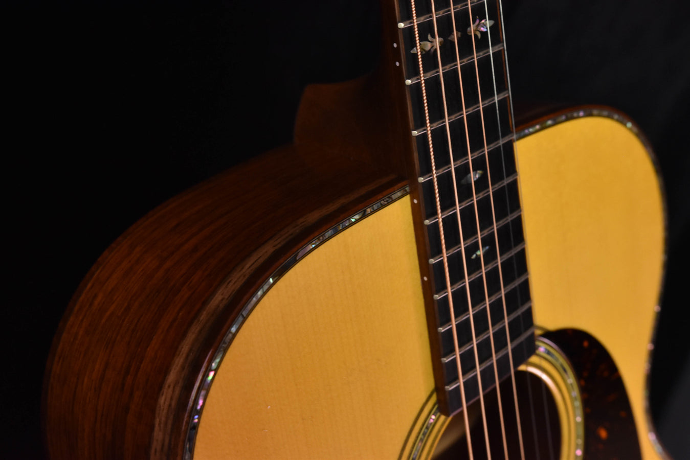 Acoustic guitar neck and upper bout with fretboard frets and decorative binding
