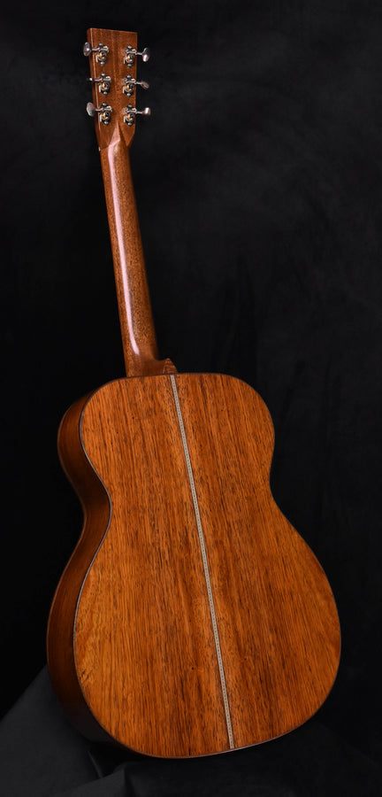 Acoustic guitar back with warm brown wood grain and center seam line