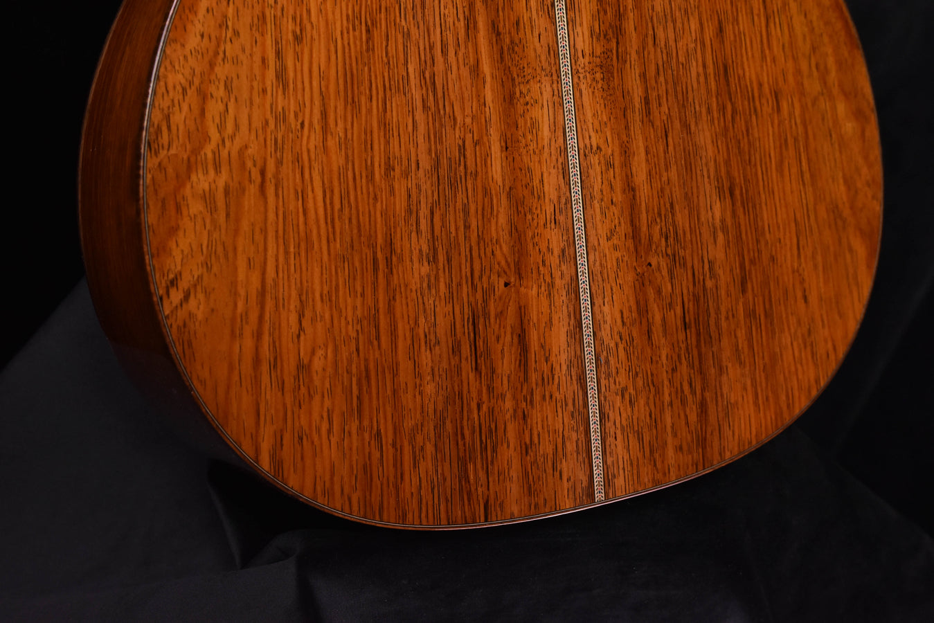 Acoustic guitar soundboard close-up with center seam and fine wood grain