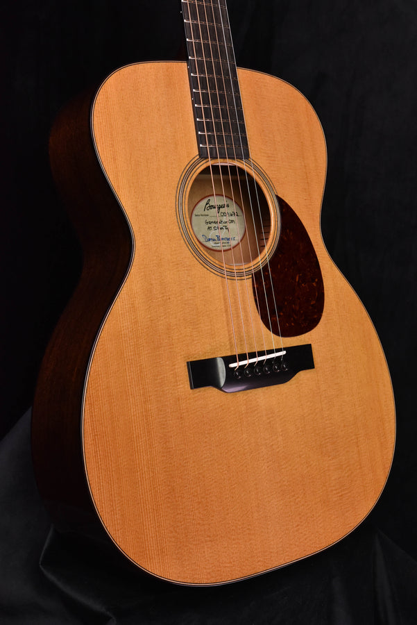 Front view acoustic guitar with soundhole rosette, strings, and black pickguard.
