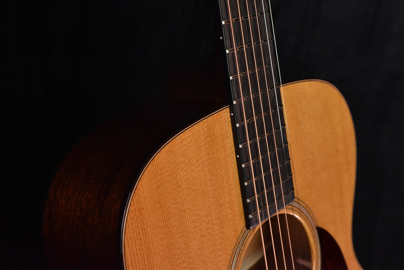 Acoustic guitar neck and frets with natural top edge, aged tone finish.