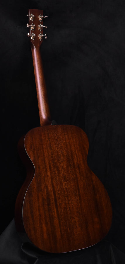 Acoustic guitar back with rich wood grain and dark brown aged finish.
