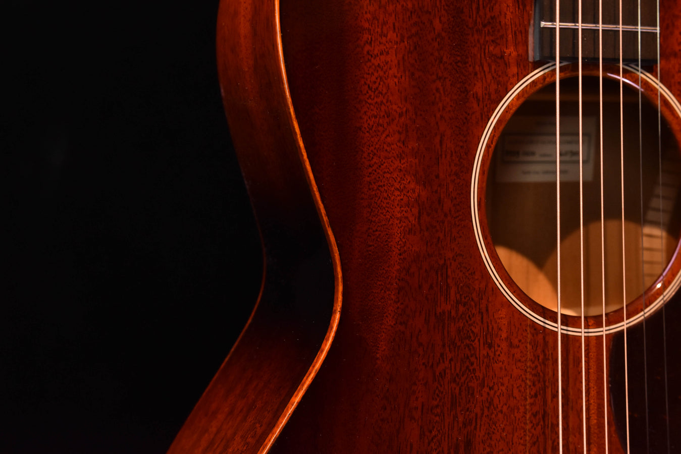 Sunburst acoustic guitar body close-up with soundhole and rosette