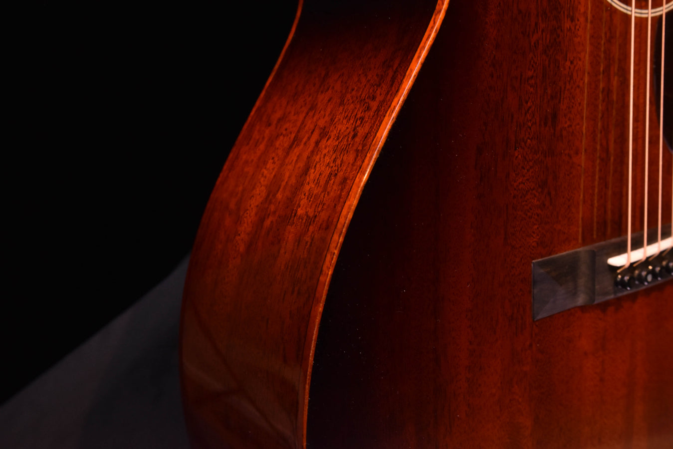Sunburst acoustic guitar side view showing curved body edge