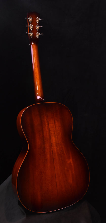 Sunburst acoustic guitar back view with arched outline and headstock