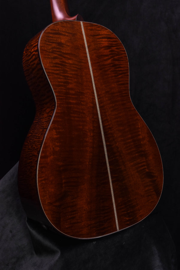 Acoustic guitar back panel close-up, quilted dark wood grain and center seam line