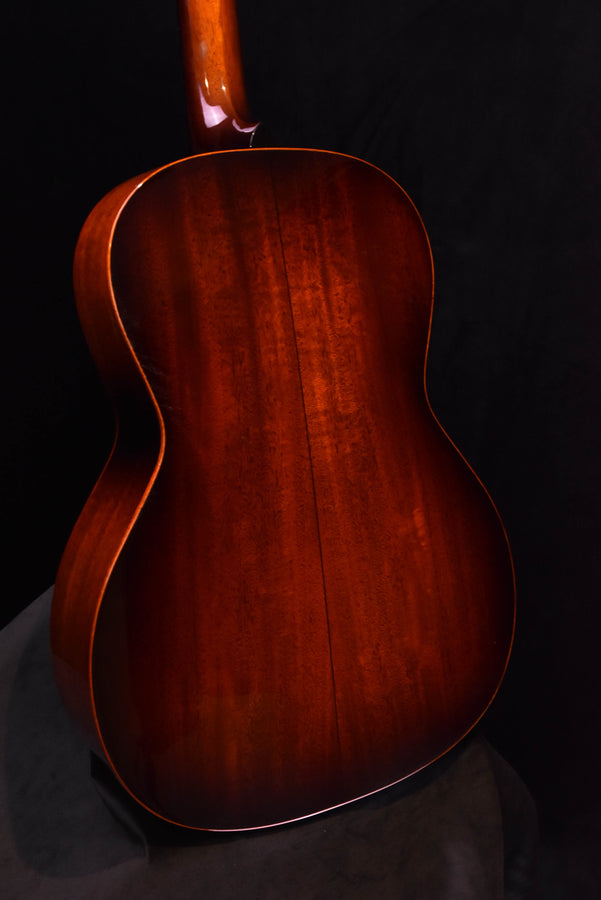 Sunburst acoustic guitar back close-up with visible grain and glossy finish
