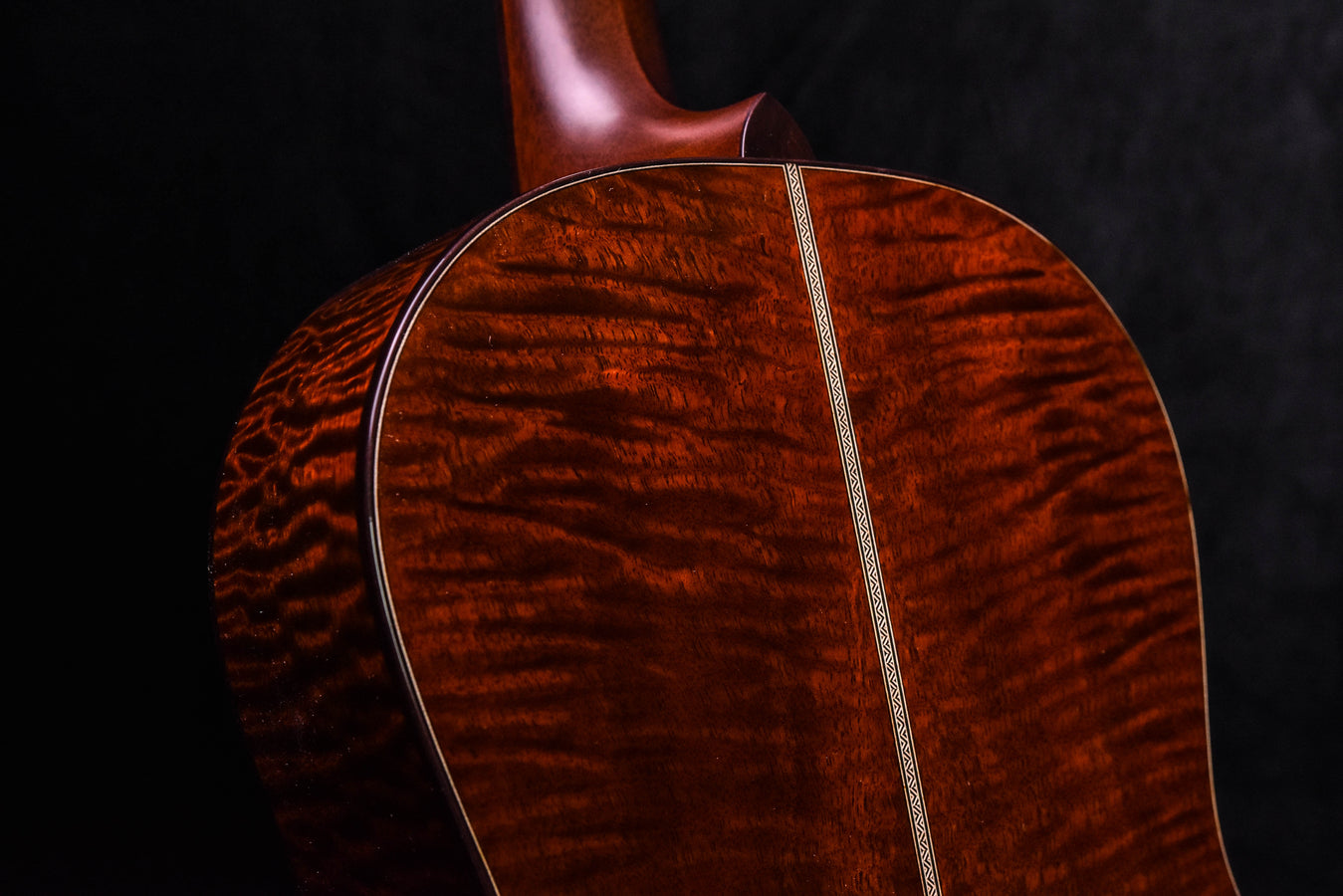 Acoustic guitar soundboard with quilted red wood figure and center trim