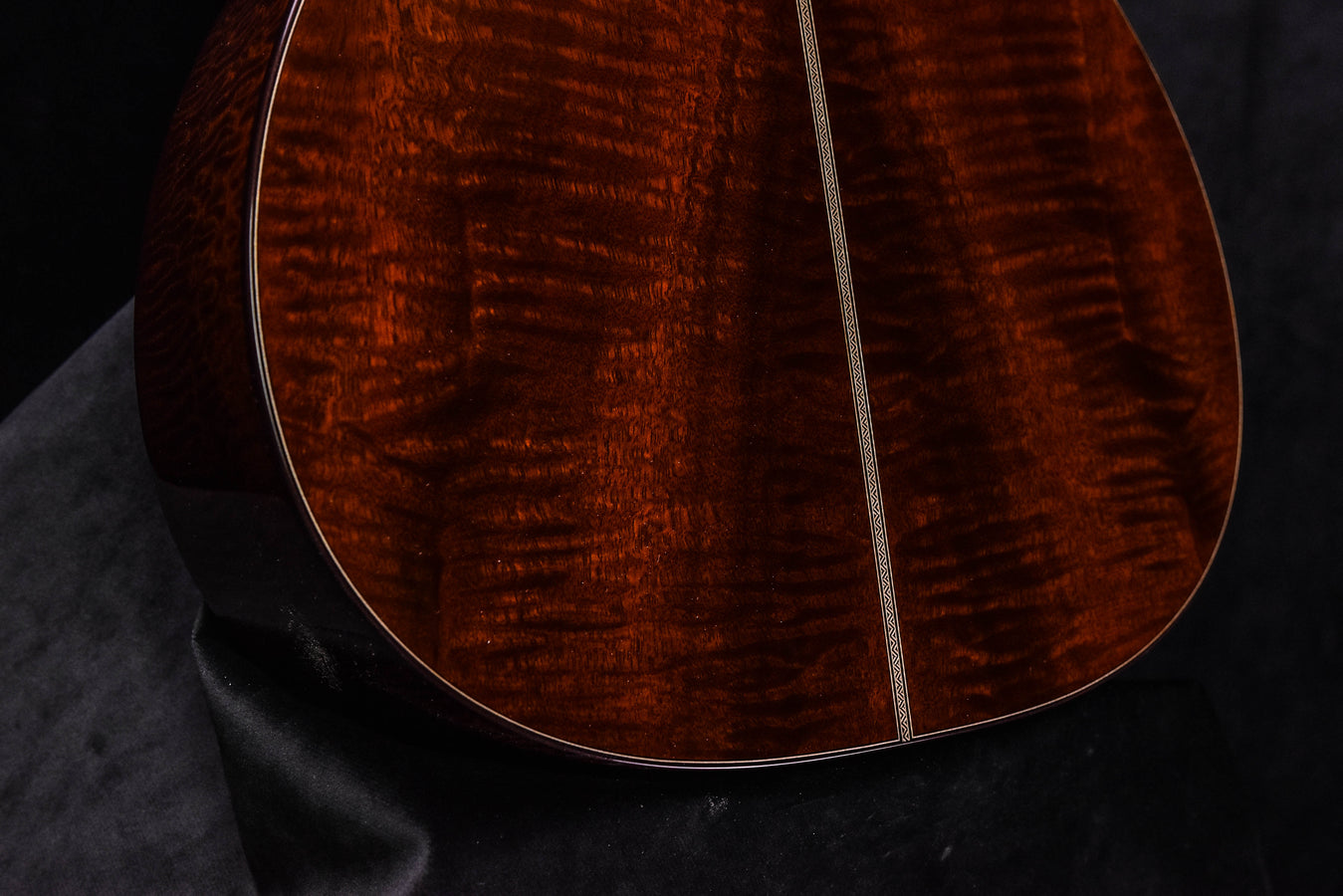 Acoustic guitar lower bout with quilted wood grain and gloss finish