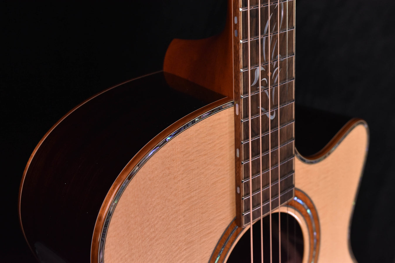 Acoustic cutaway guitar neck and upper bout with fretboard and side of body