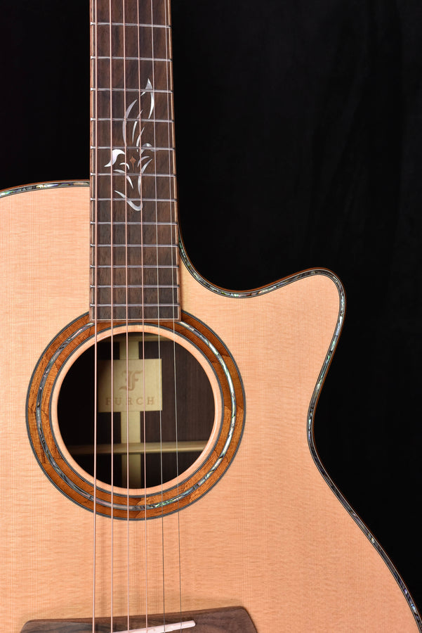 Acoustic cutaway guitar view of soundhole rosette and neck join with fretboard lines