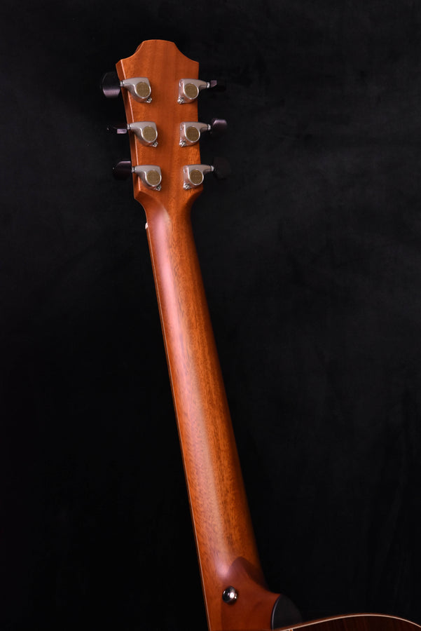 Red guitar headstock with six tuning pegs and chrome tuners