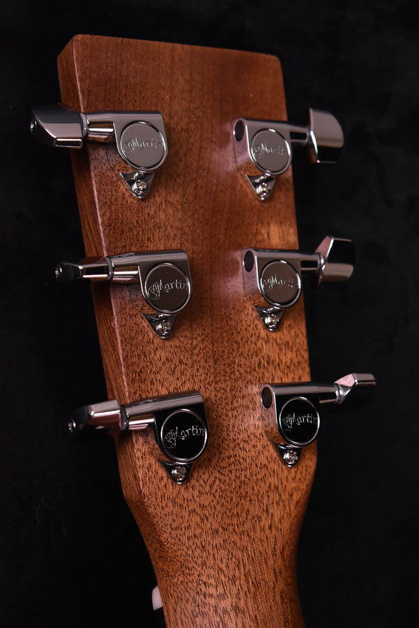 Acoustic-electric guitar headstock, chrome tuners, Martin logo on wood