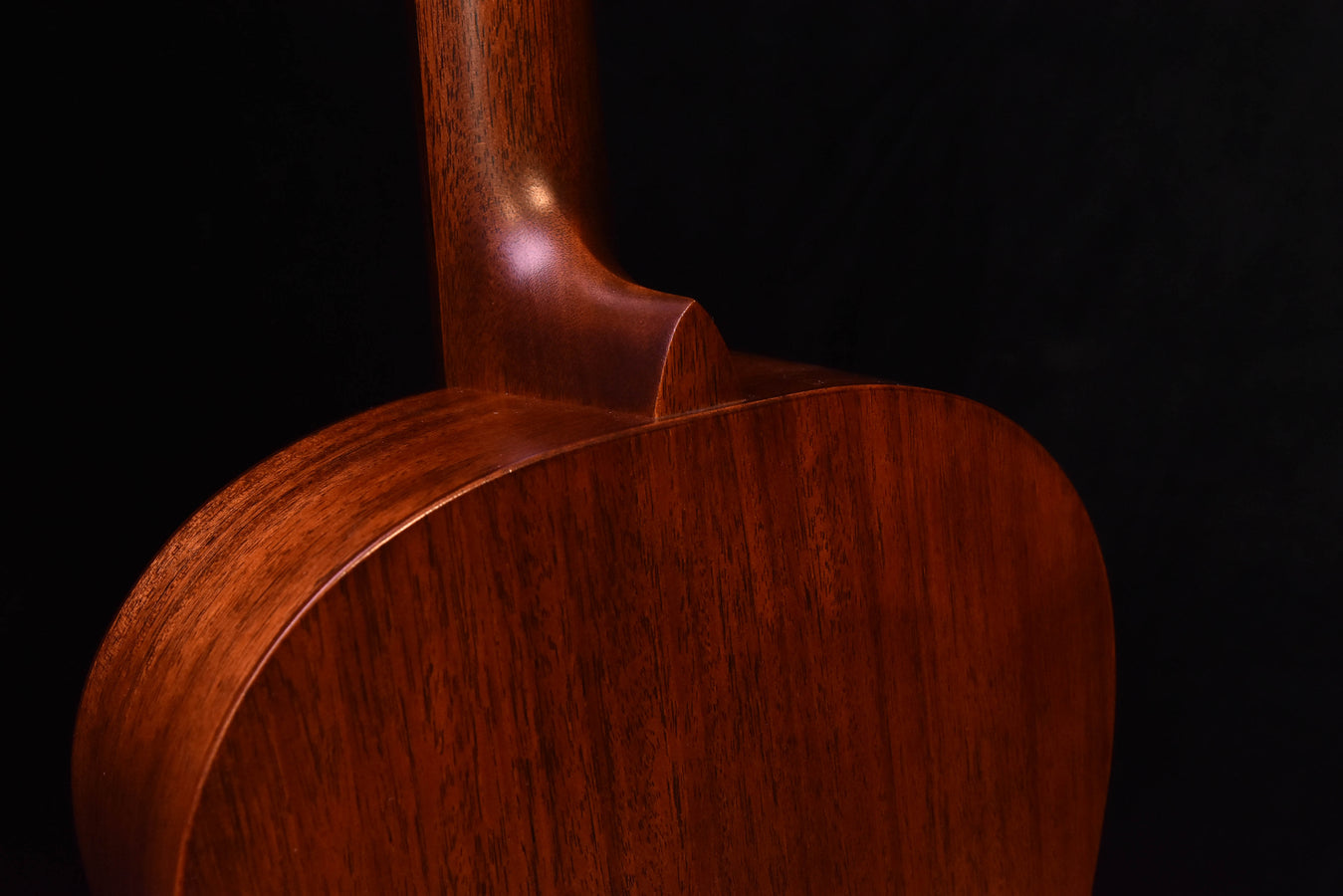 Mahogany neck joint and upper bout on an acoustic guitar