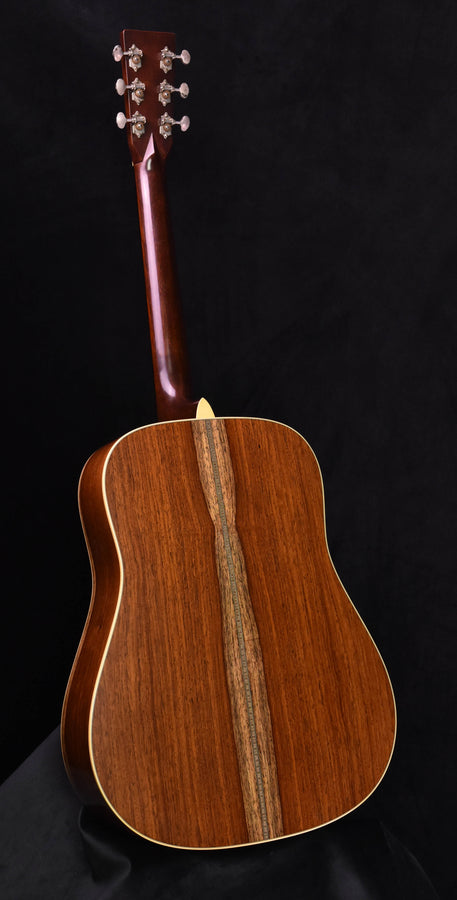 Acoustic guitar back view in warm brown wood with dark center stripe and bound edges