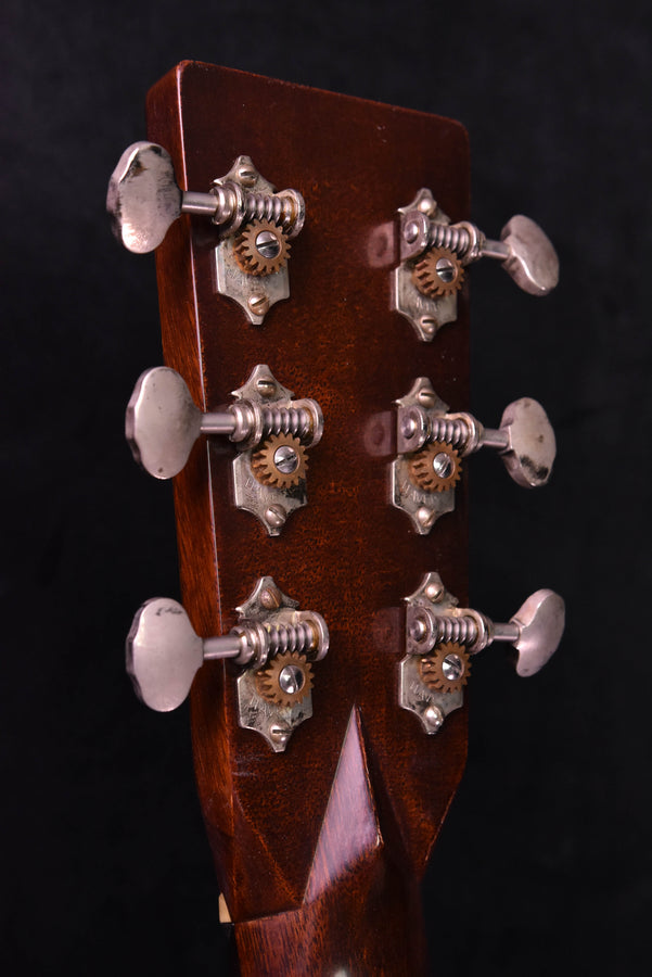 Acoustic guitar headstock with chrome tuners and tuning key hardware