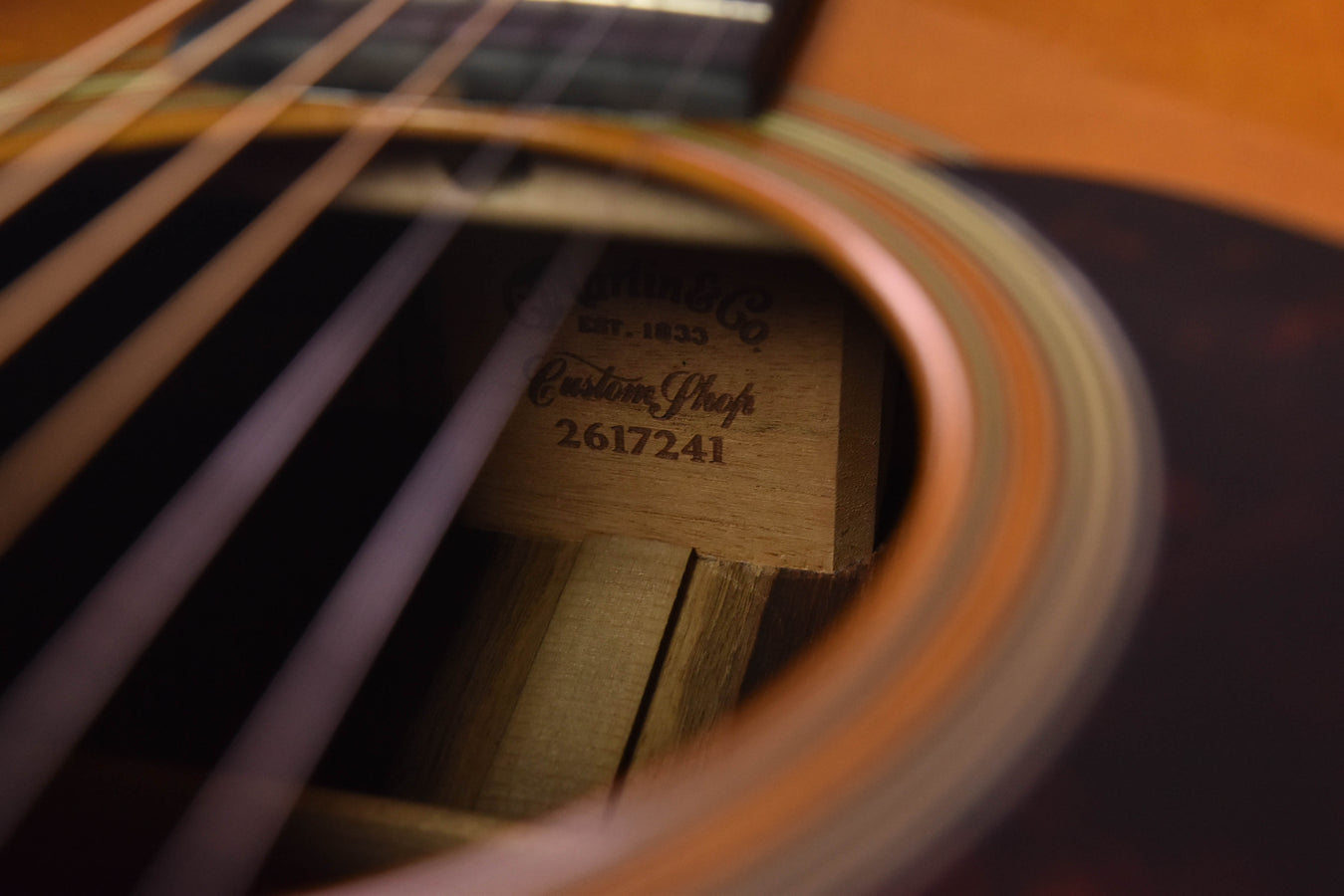 Inside soundhole view with engraved label on wooden spruce top
