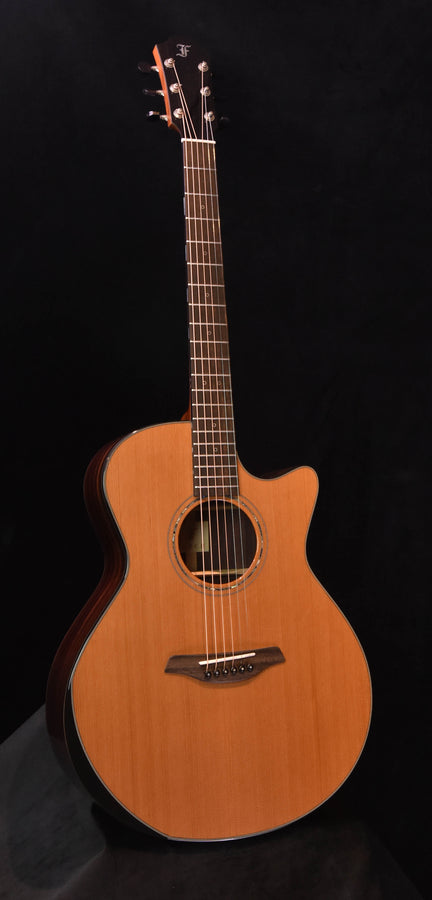 Yellow acoustic cutaway guitar, round sound hole and steel strings