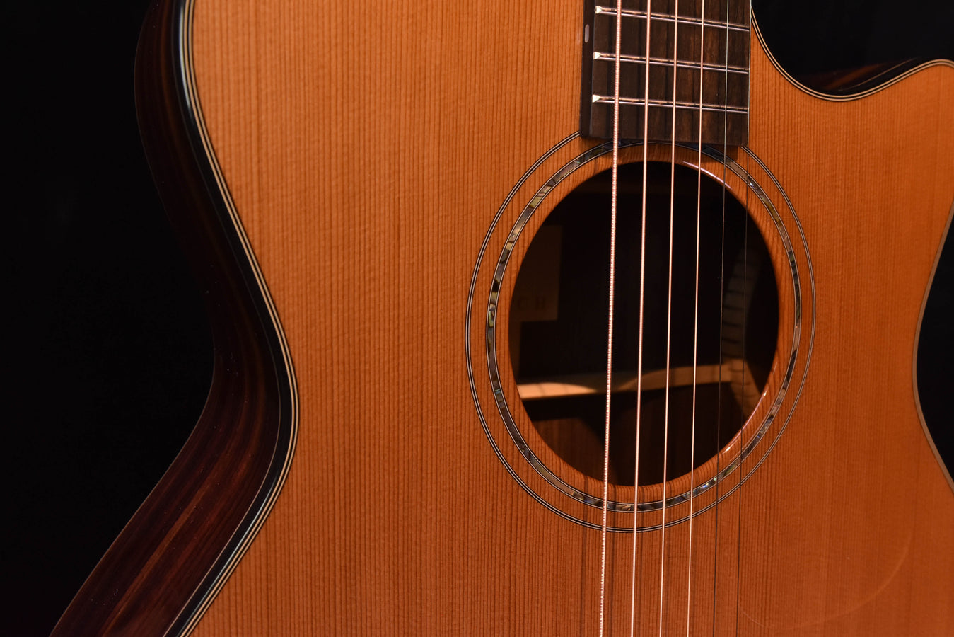 Rosette close-up around the sound hole on yellow acoustic guitar