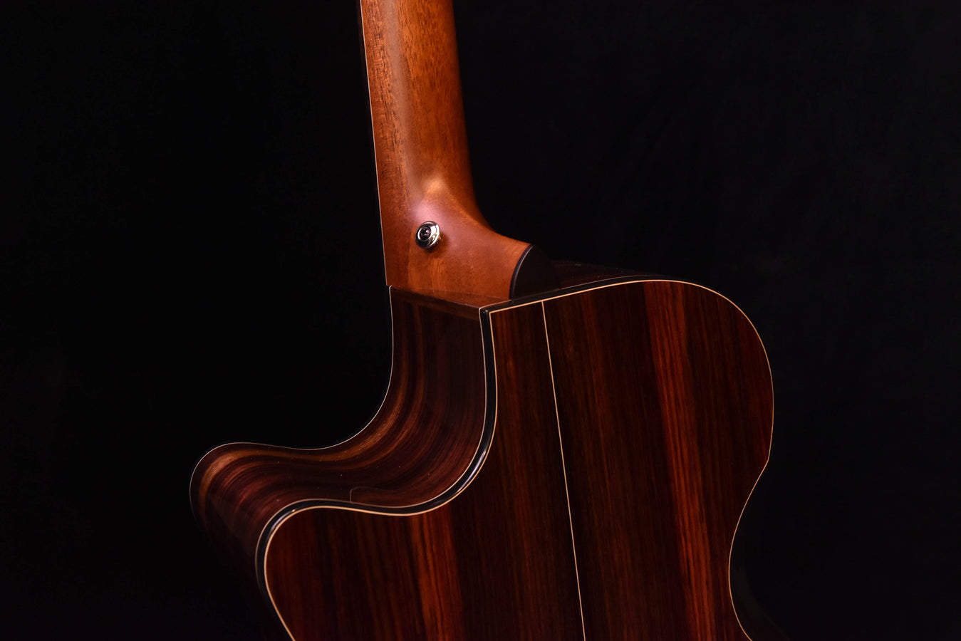 Cutaway acoustic guitar body with dark wood sides and warm brown finish
