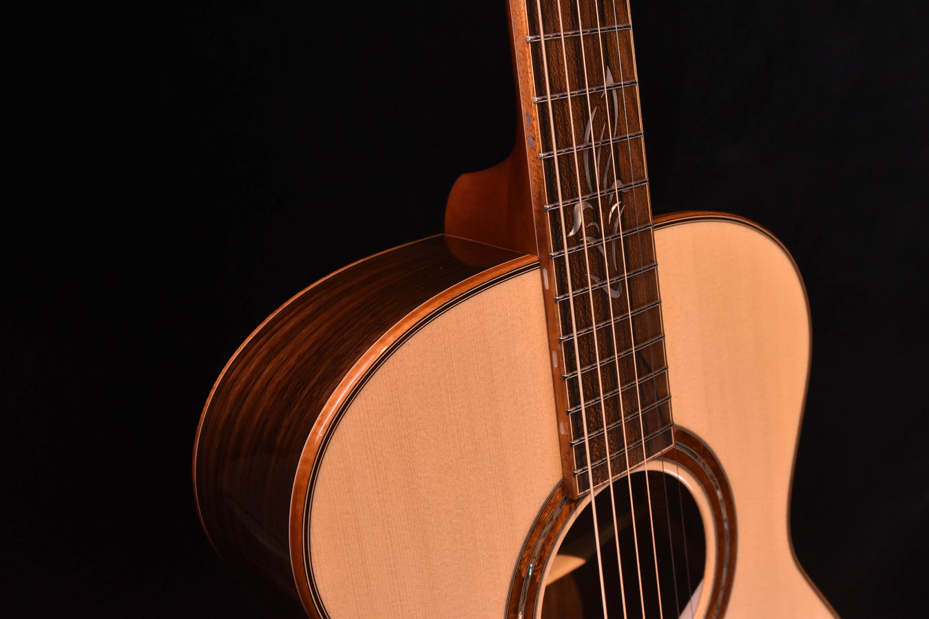 Close-up of used acoustic guitar neck and upper body with side binding
