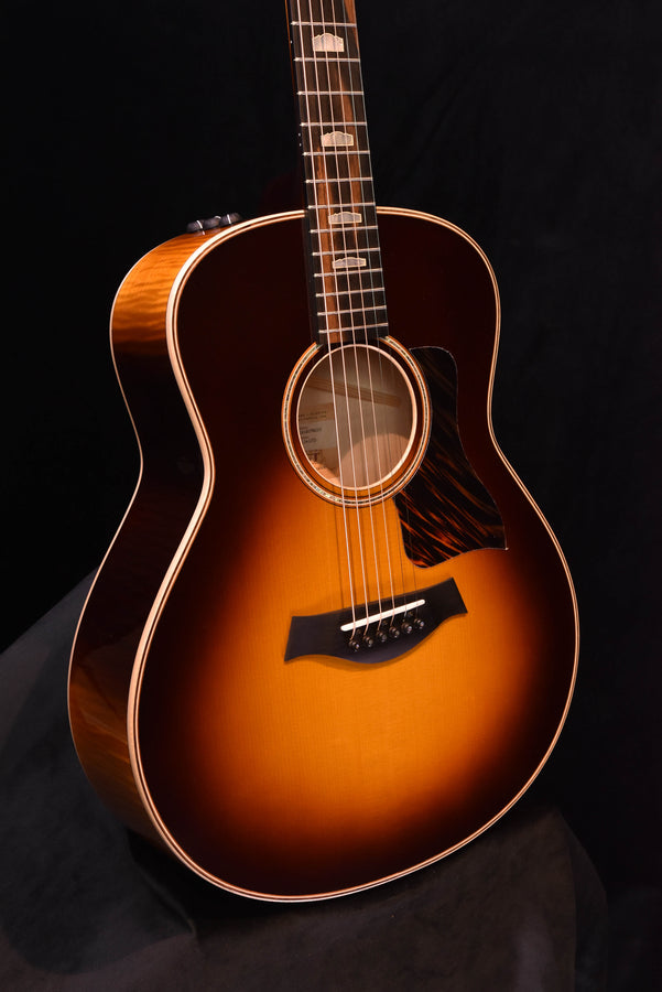 Acoustic guitar with tobacco sunburst body and dark pickguard, three-quarter front