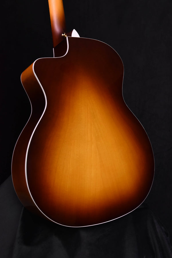Acoustic-electric guitar back/side view, sunburst brown finish with white binding, full body