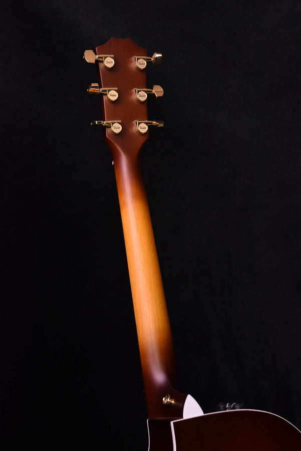 Mahogany-toned guitar headstock with six chrome tuners
