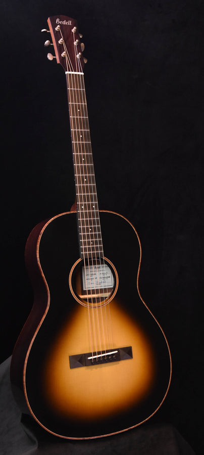 Bedell acoustic guitar with sunburst body and rosewood-style neck, headstock visible