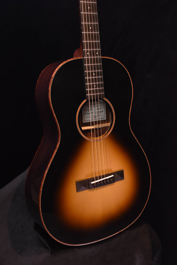 Acoustic guitar, sunburst finish with black pickguard and sound hole rosette