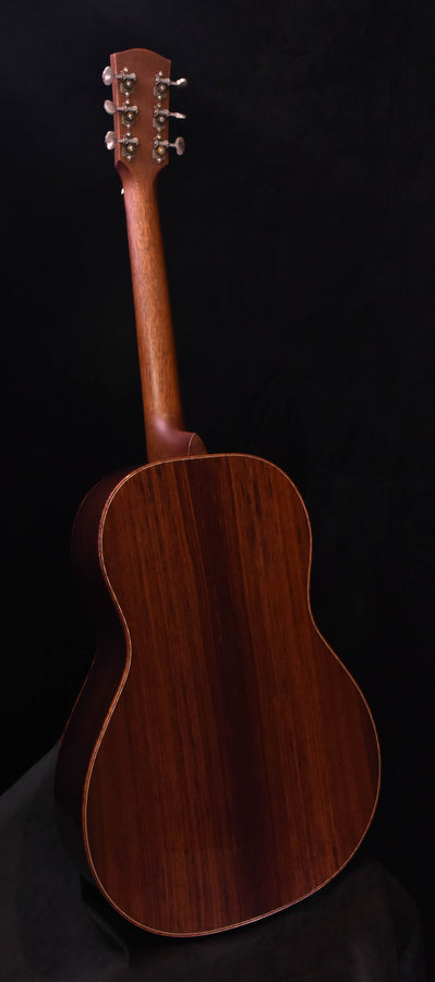 Acoustic guitar back view with dark wood grain and body outline