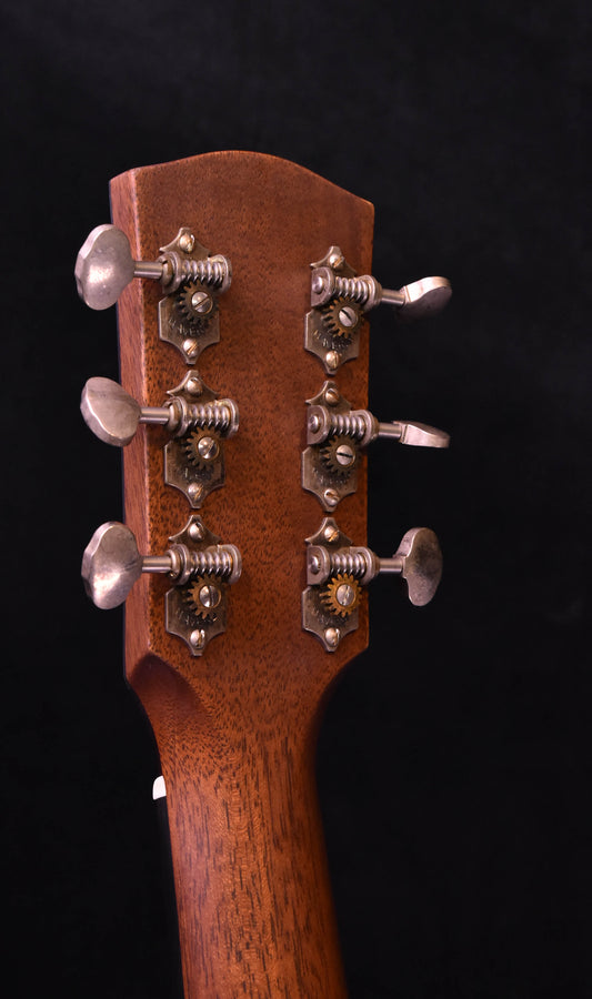 Acoustic guitar headstock with chrome tuning pegs, dark brown wood finish
