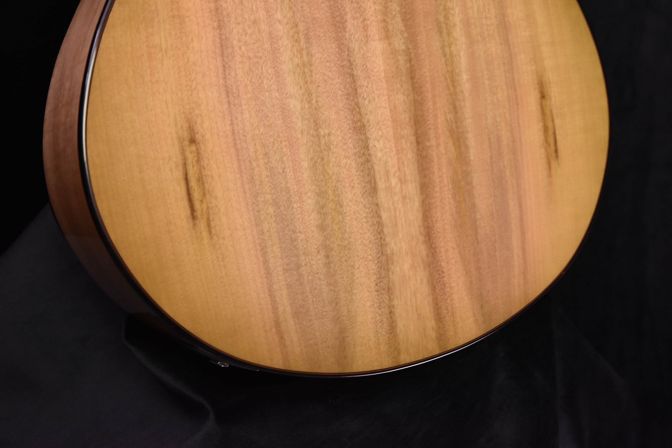 Close-up of natural wood guitar top with prominent swirling grain