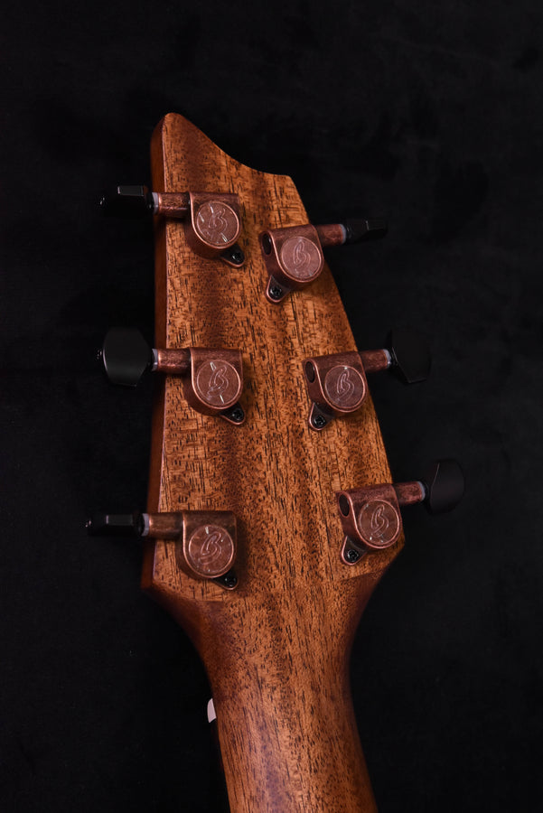 Headstock with six tuning machines and warm wood finish